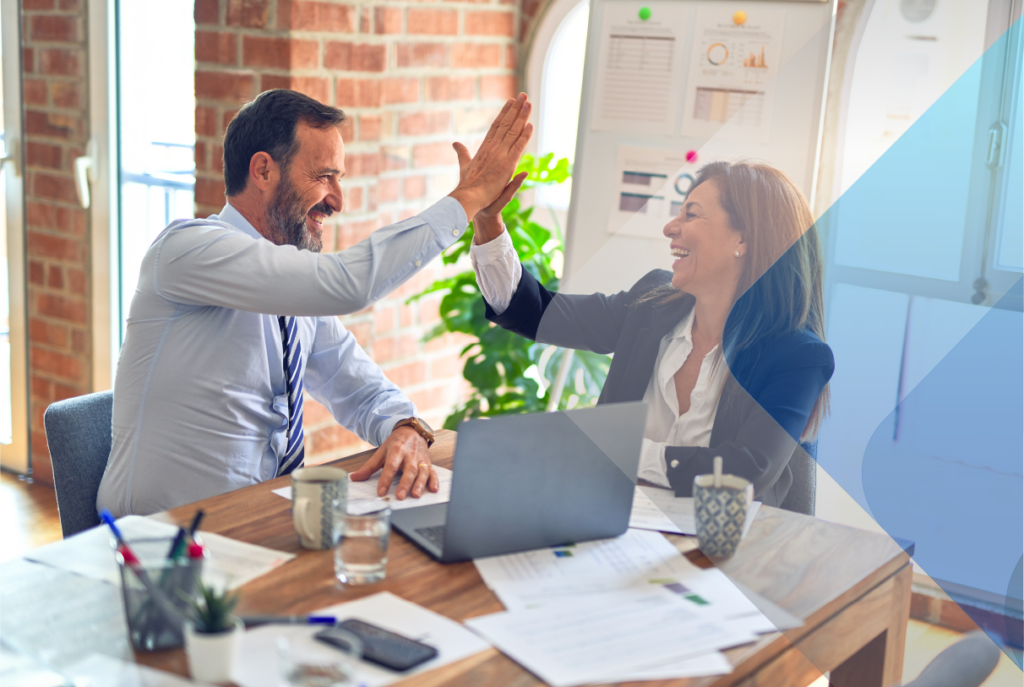 Stock image of professionals celebrating to accompany article on employer of record vs PEO.