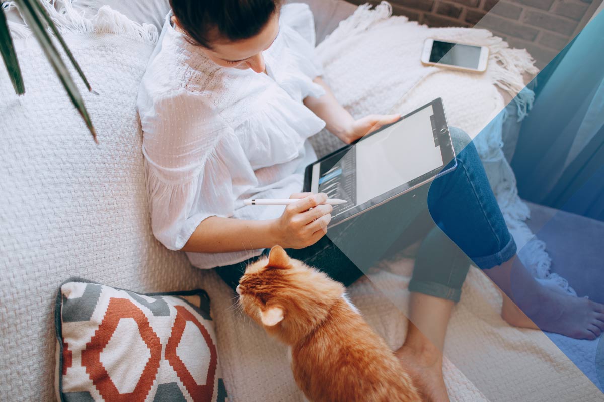 Stock image of someone working at home with their cat to accompany article on emotional salary helena-lopes-RgPQNvoIcdg-unsplash