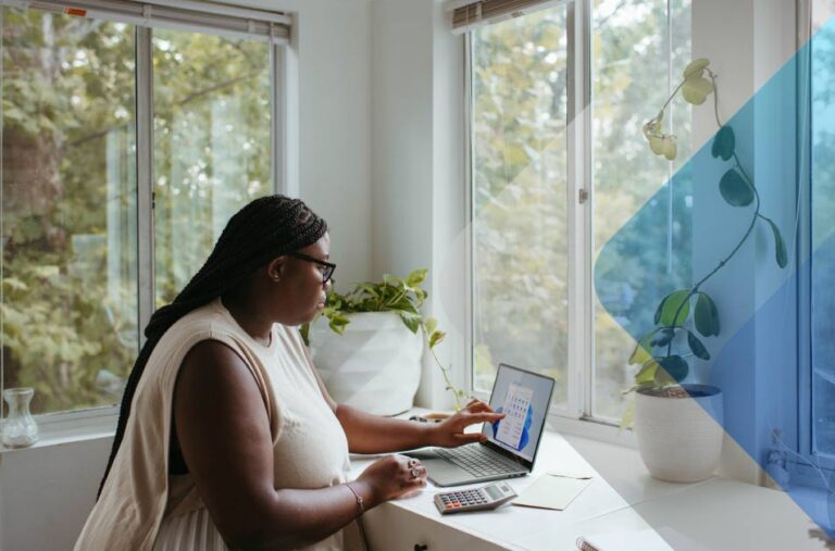 A photo of a person using a laptop to accompany article on distributed workforce management