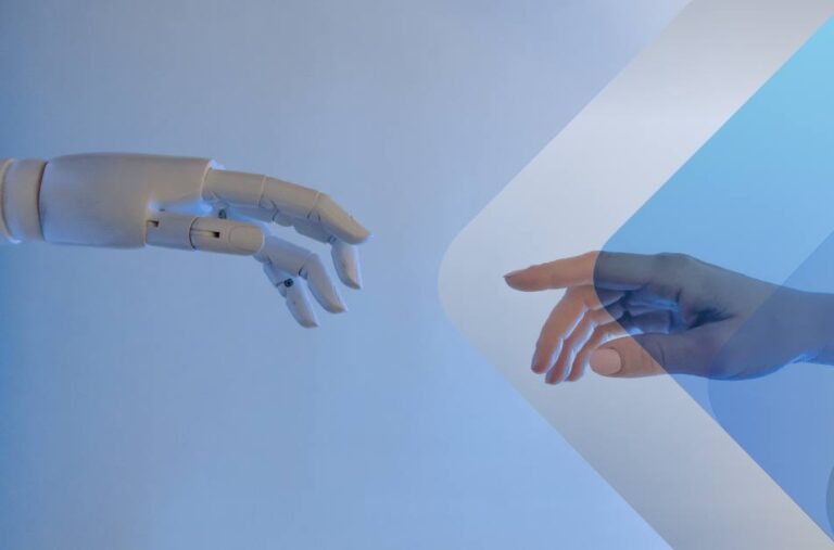 Image of robot hand and human hand to illustrate article on AI recruiting tools