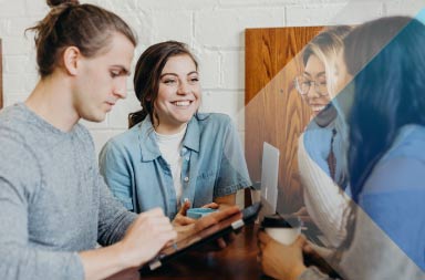 People working to illustrate article on hiring international contractors. By Brooke Cable on Unsplash.