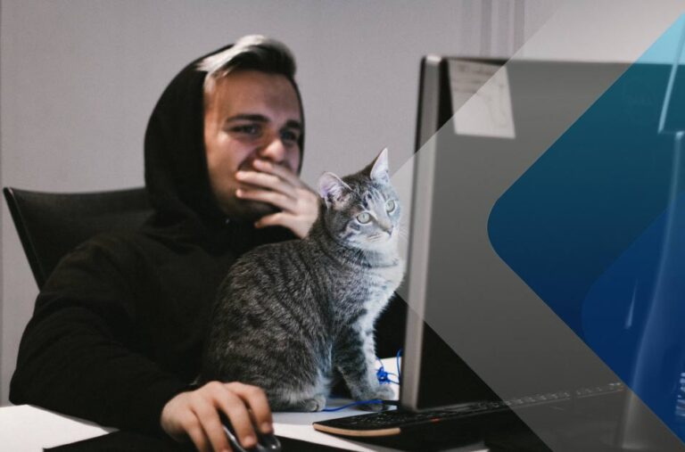 Adorable cat with man at computer to illustrate article on global hiring. Photo by GA on Unsplash.