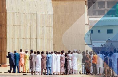 Queue of men outside a mosque in Abuja to illustrate article on EOR in Nigeria. Photo by Habila Masawaje
