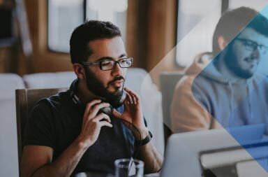 Man at computer to illustrate article on global recruiting. By Annie Spratt on Unsplash. 