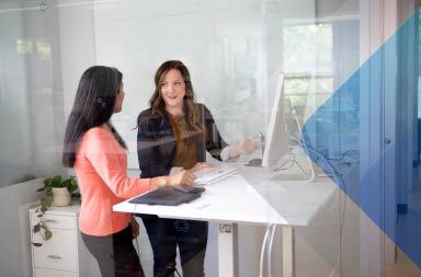 Fotografía de dos mujeres charlando para ilustrar un artículo sobre contratación global. Por LinkedIn Sales Solutions en Unsplash.