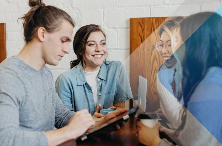 Four young people talking to illustrate article on mananging a global workforce. By Brooke Cagle on Unsplash