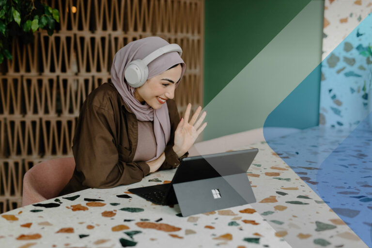 Woman working at laptop to illustrate article on challenges of managing remote teams. By Windows on Unsplash