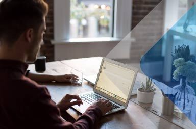 A stock image of a person using a computer to represent a remote worker hired using employer of record solutions.