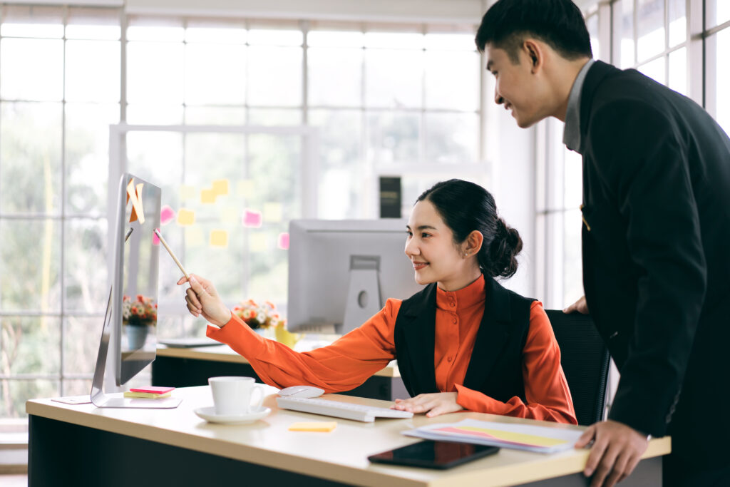 Employees in an office calculating the 13th month pay together.